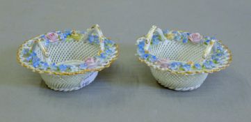 A pair of pierced floral porcelain baskets. 9 cm diameter.