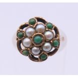 A 9 ct gold turquoise and seed pearl ring. Ring size H.