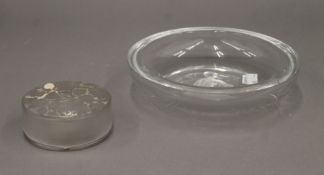 An R Lalique glass powder pot and a Lalique style glass dish. The former 8.5 cm diameter.