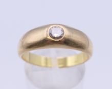 An 18 ct gold gypsy set diamond solitaire ring. Ring size S/T. 7.3 grammes total weight.