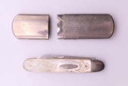 A silver and mother-of-pearl folding fruit knife (10.5 cm long extended) and a match holder.