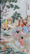 A framed Chinese painted porcelain panel depicting various figures in a garden. 61.