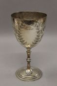 A 1907 silver plated trophy cup. 22 cm high.