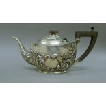 A silver teapot. 24 cm long. 304 grammes total weight.