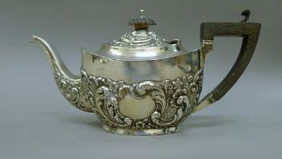 A silver teapot. 24 cm long. 304 grammes total weight.