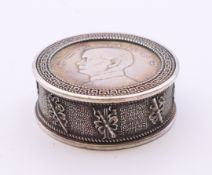 A Chinese white metal coin box. 5 cm diameter.