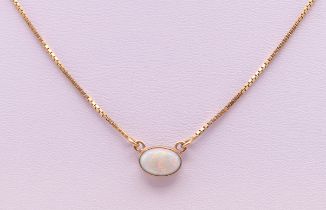 A 9 ct gold and opal pendant on chain. The pendant 9 mm wide. 3 grammes total weight.