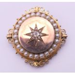 A Victorian unmarked gold seed pearl and diamond set pendant/brooch. 3.5 cm diameter. 13.