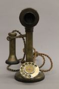 A brass candlestick telephone. 31 cm high.