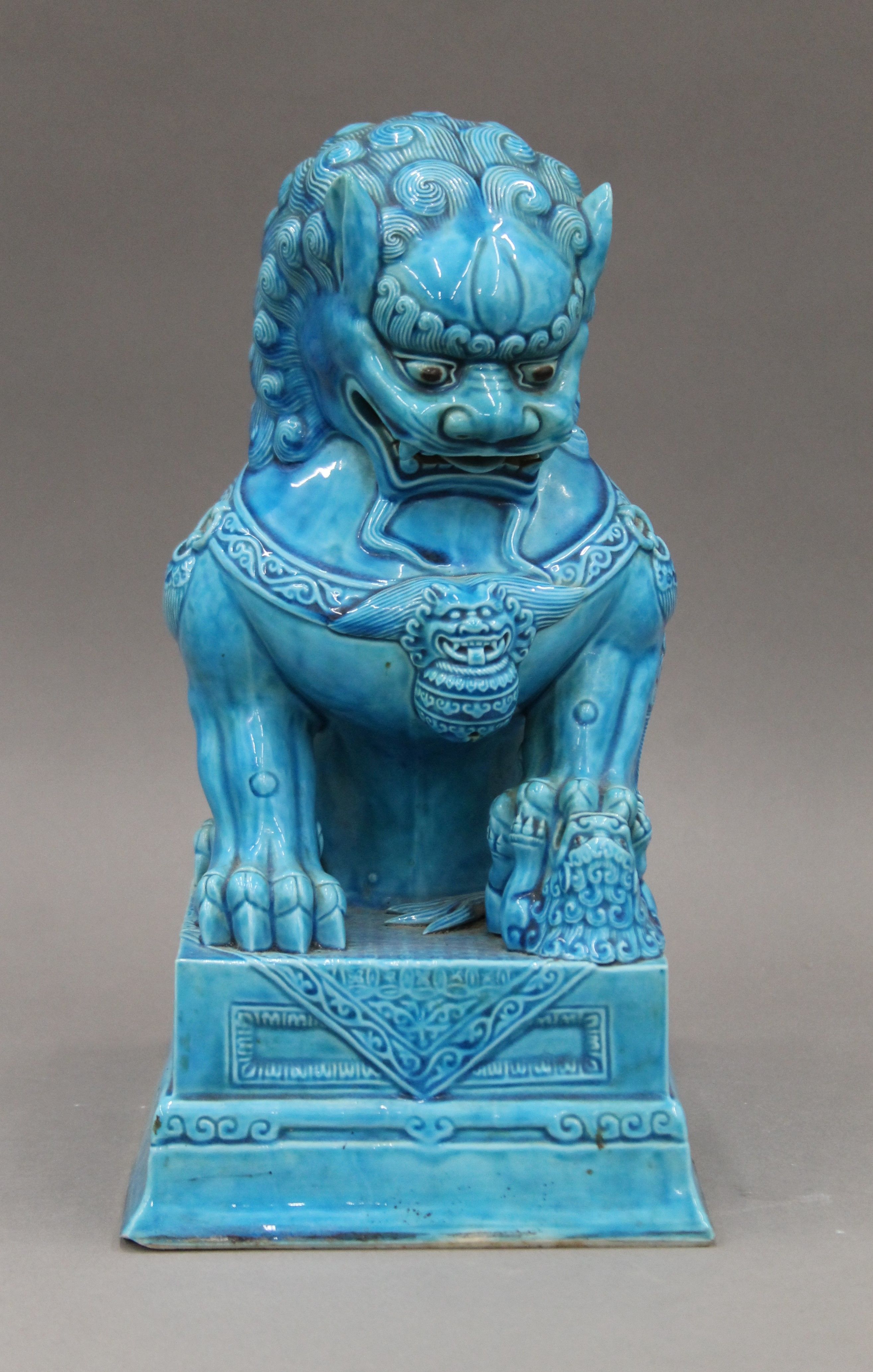 A Chinese turquoise ground porcelain dog-of-fo. 30 cm high.