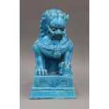 A Chinese turquoise ground porcelain dog-of-fo. 30 cm high.