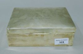 A silver cigarette box with presentation inscription. 18 cm wide.