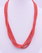 A four strand red coral bead necklace. 44 cm long.