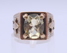 A 9 ct gold peridot ring. Ring size J/K. 6.8 grammes total weight.