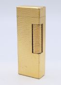 A Dunhill gold plated lighter. 6.25 cm high.