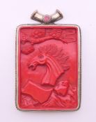 A Tibetan cinnabar pendant. 9 cm high.
