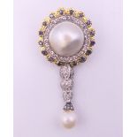An 18 ct gold pearl and diamond brooch. 5 cm high.