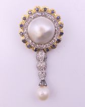 An 18 ct gold pearl and diamond brooch. 5 cm high.