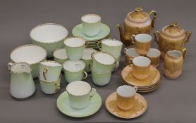 A Venetian gilt decorated porcelain tea set, and a green and gilt tea set.