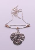 An Art Nouveau silver pendant on chain. 6 cm wide.