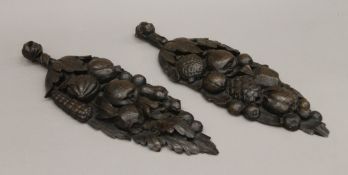 A pair of antique oak carved wall hangings. 43 cm long.