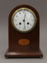 A Victorian inlaid mahogany mantle clock. 25 cm high.