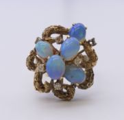 A 14 ct gold opal and diamond ring. Ring size M.