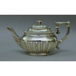 A silver teapot. 21.5 cm long. 382.9 grammes total weight.