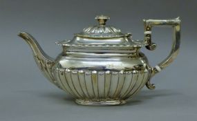 A silver teapot. 21.5 cm long. 382.9 grammes total weight.