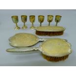 Six small silver wine cups, two sterling silver brushes and a mirror. The cups each 7.5 cm high.