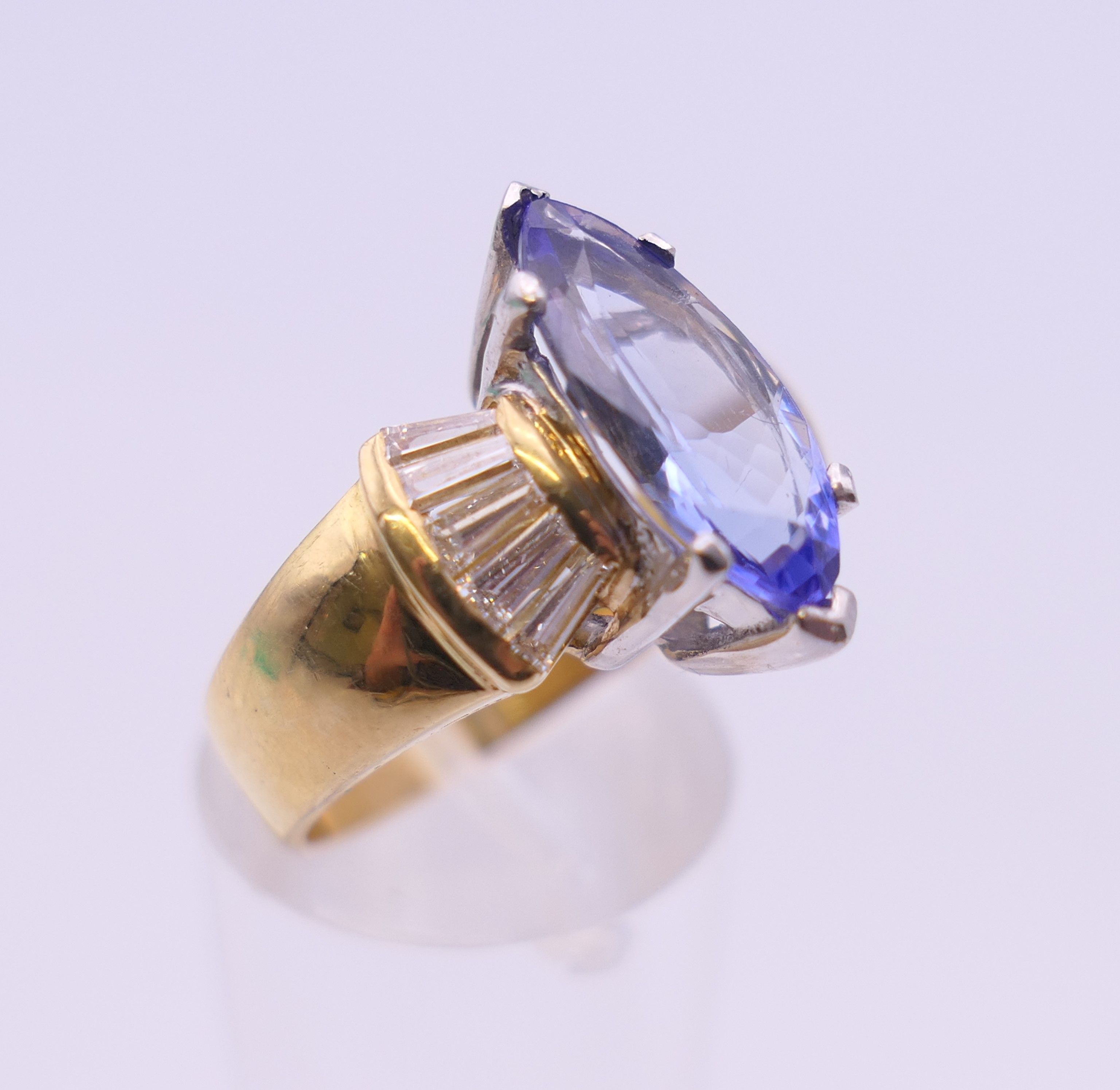 An 18 ct gold tanzanite and baguette diamond ring. Ring size O/P. - Image 2 of 8