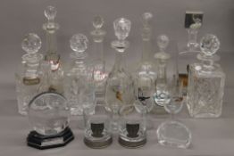 A quantity of various decanters, etc.