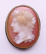 A 19th century French 18 ct gold hardstone cameo and enamel brooch. 4 cm high.