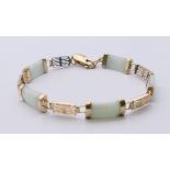 A Chinese 9 ct gold and jade bracelet. 16 cm long.