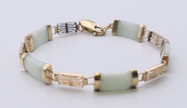 A Chinese 9 ct gold and jade bracelet. 16 cm long.