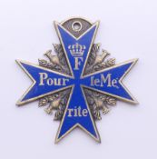 A Continental blue enamel medallion. 5 cm wide.