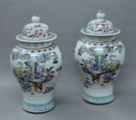 A pair of Chinese porcelain lidded vases. Approximately 38 cm high.