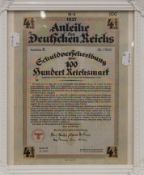 A German Nazi Reichsmark Bond dated 1937, housed in a white frame. 31 x 36 cm overall.