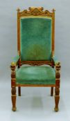 An early 20th century carved oak open armchair. 66 cm wide.