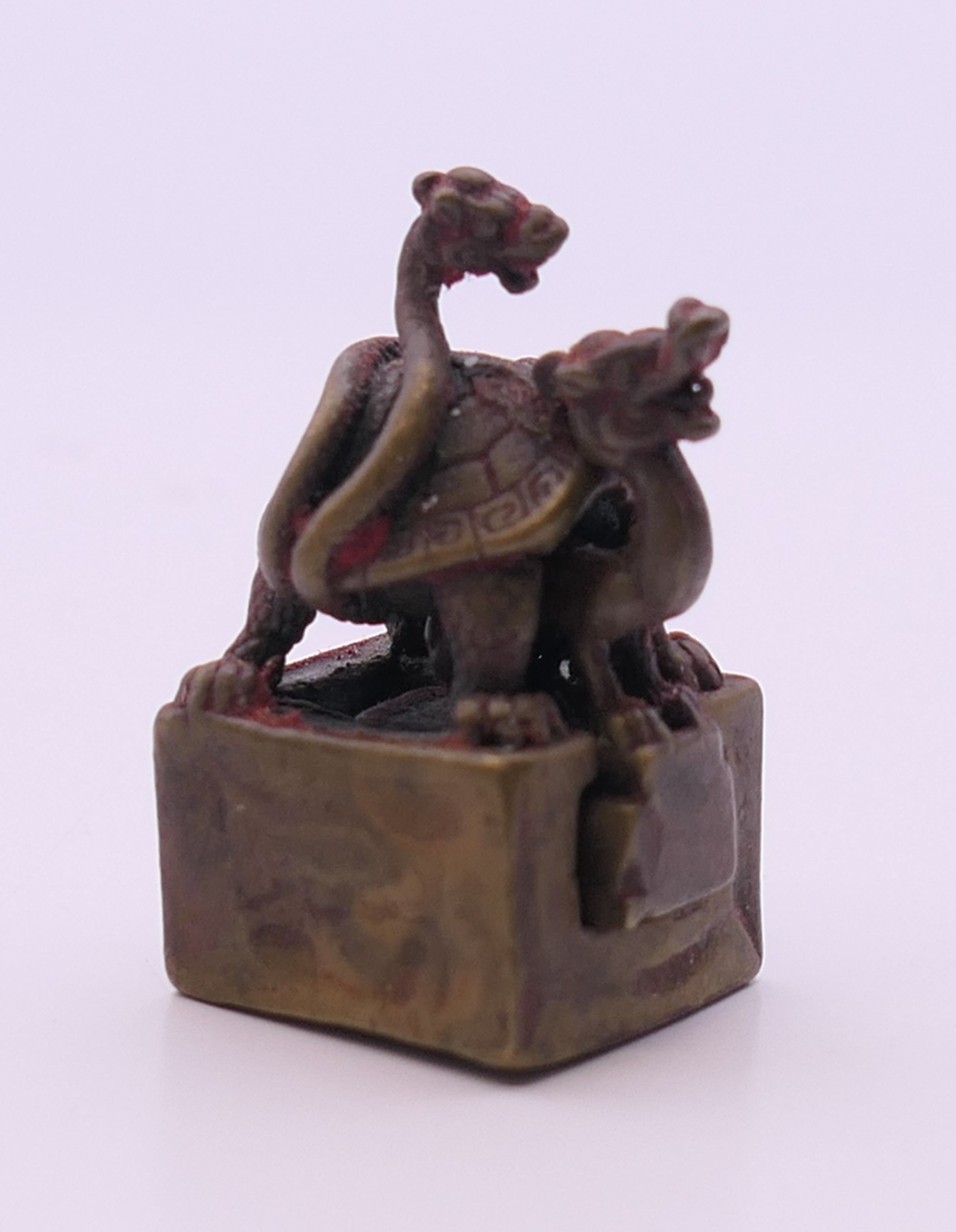 A miniature bronze double turtle seal. 3 cm high.