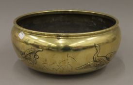 A Japanese bronze jardiniere decorated with geese. 32 cm diameter.