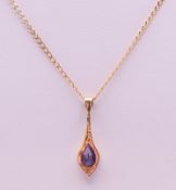 A 9 K gold and amethyst pendant on a 9 K gold chain. The pendant 2.25 cm high. 2.