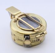 A brass military compass. 8.5 cm high.