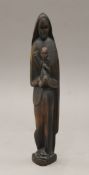 A carved wooden figure of The Madonna and Child. 29 cm high.