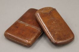Two leather cigar cases. The largest 14.5 cm high.