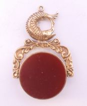 A 9 ct gold bloodstone and carnelian swing fob set with fish. 4 cm high. 12.3 grammes total weight.