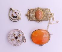 Three 9 ct gold brooches and a 9 ct gold pendant. The latter 2.5 cm diameter. 16.