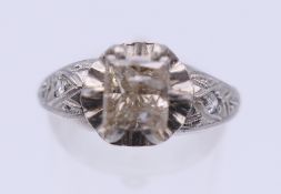 An Edwardian style platinum and diamond ring, the shoulders grain set with two small diamonds.