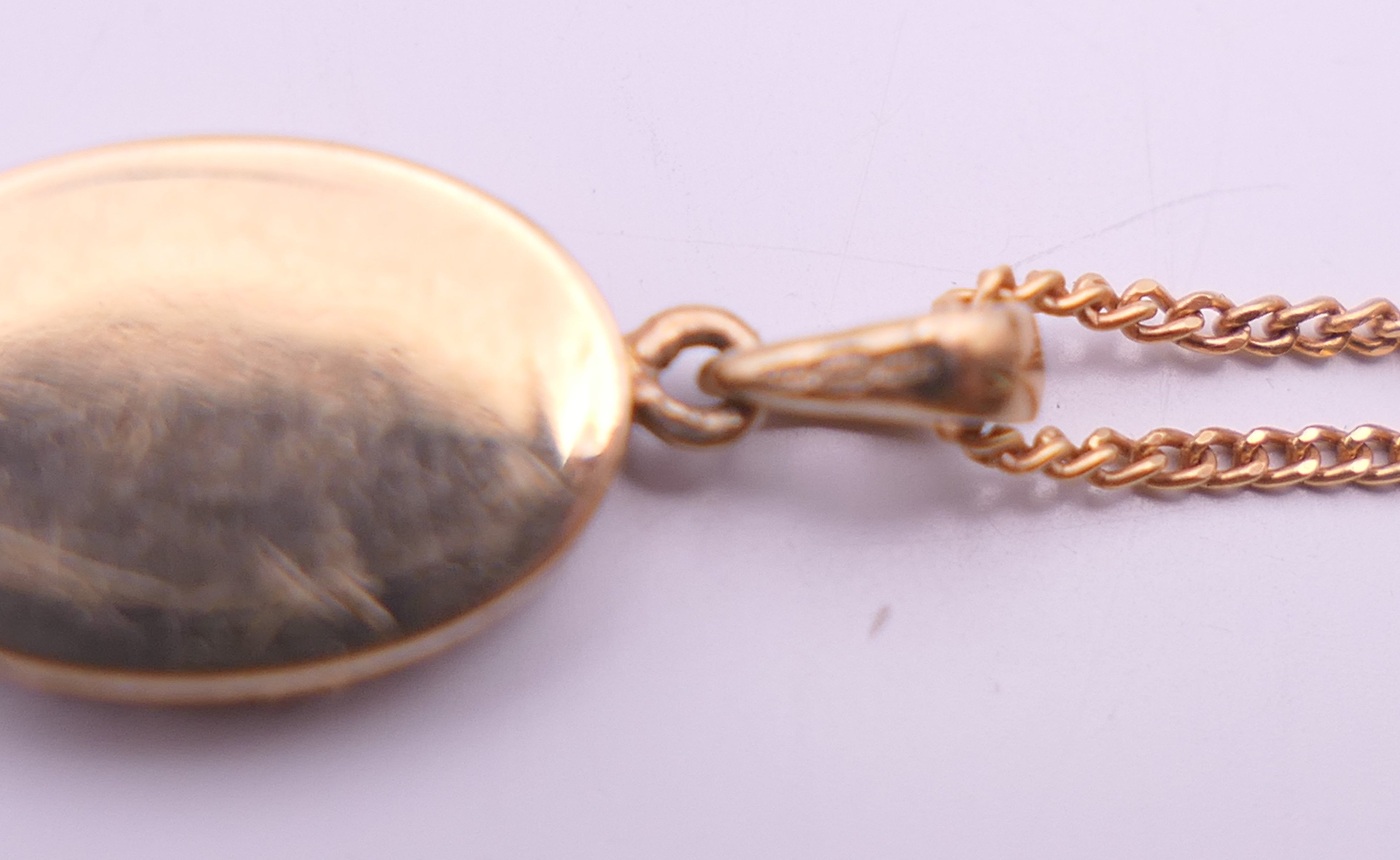 A 9 ct gold and diamond oval pendant on a 9 ct gold chain. Pendant 1. - Image 6 of 10
