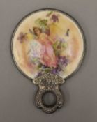 A silver hand mirror. 11.5 cm diameter.